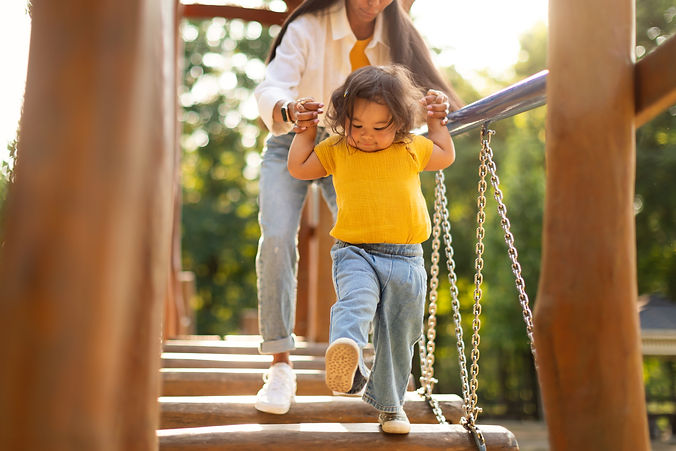 Asian Mommy With Toddler Baby Daughter Walking Swinging Bridge Together, Having Fun At Mod