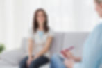 Therapist and client engaged in a deep conversation during a therapy session