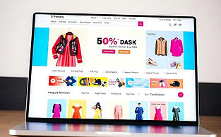Laptop displaying e-commerce website with 50% discount and various clothing options.