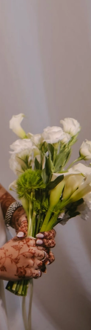 Hands arranging white calla lilies for wedding