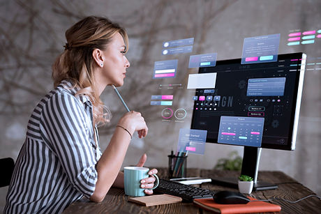 Woman working on computer with interface, holding a coffee cup, thinking DOT IT AE