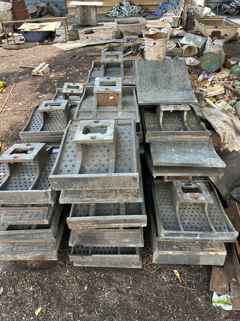 A stack of heavy, gray metal blocks or ingots.