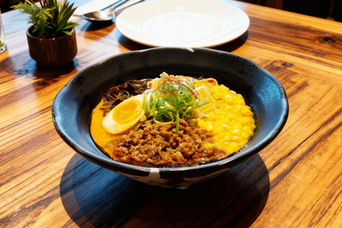 Delicious ramen bowl with egg and meat on wooden table SAKURA TOKYO