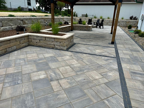 a polished landscape design featuring pavers and plants 