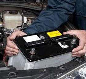 Close-up of a properly secured car battery in engine bay