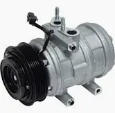 Close-up of an automotive A/C compressor featuring a black pulley and electrical connector, mounted on an engine block.