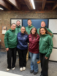 Six Fuss & O'Neill team members standing in an office