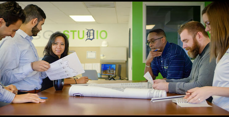 Team members collaborating at a design studio