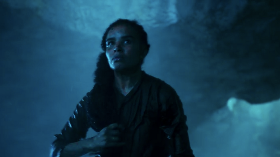Zoe Robins as Nynaeve clutching her braid in a dark cavern