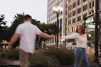 Engagement photo of couple walking in Downtown Detroit Michigan