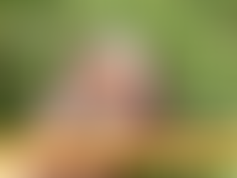 Hands holding a frothy mug of low-sugar hot chocolate over green grass with text highlighting its health benefits.