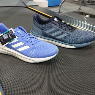 The right foot of the men's and women's Adidas Solar Drive ST posing on a shop treadmill