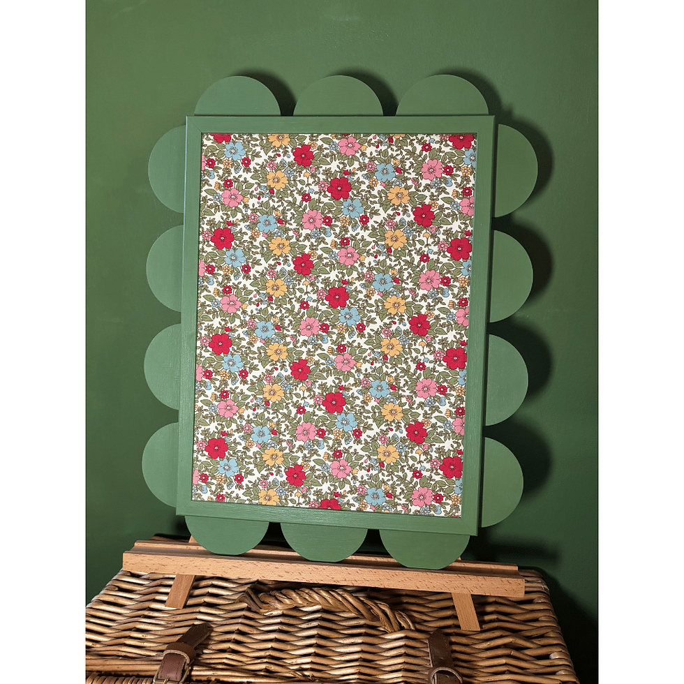 JoJo small scalloped noticeboard on easel, balanced on wicker picnic basket