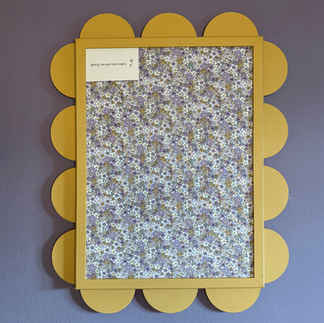 Yellow noticeboard with gentle lavender floral fabric pattern