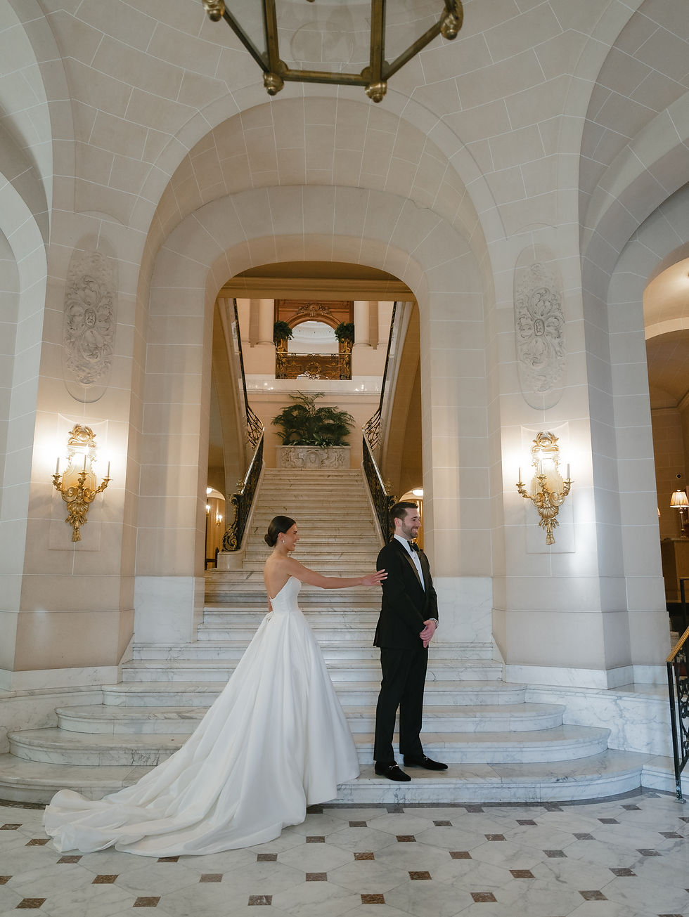 Bride and groom during their first look on the marble staircase at the Perry Belmont House.