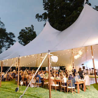 Romantic sailcloth tent reception with string lights at an Eastern Shore wedding