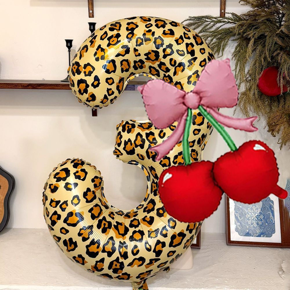 Make birthdays pop with a Leopard Print Cherry Bow Number Balloon, featuring bold leopard print, red cherries and a pink bow