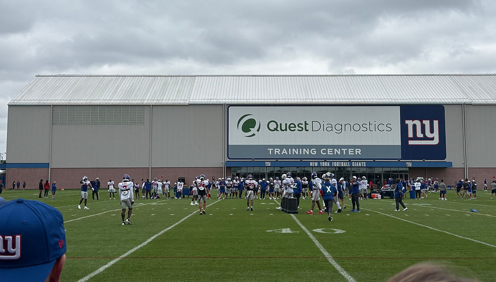 The defense runs through schemes and sequences under an overcast sky at training camp practice #8