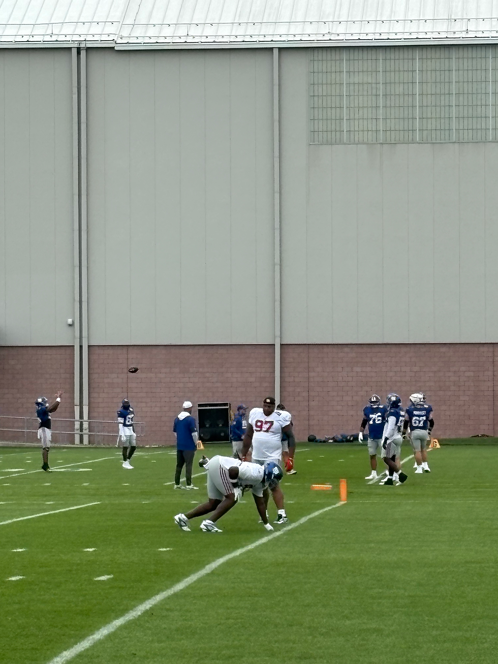 Lawrence II and rookie Darius Alexander talk technique before practice begins