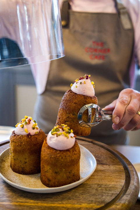 Close-up of freshly prepared pastries being served in a café