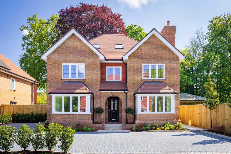Contemporary family home with red-brick exterior and landscaped garden
