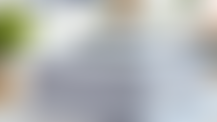 Stack of organised tax and financial documents on a desk with a pen placed on top, representing tax filing, record keeping, compliance paperwork, and business documentation in a professional office setting.