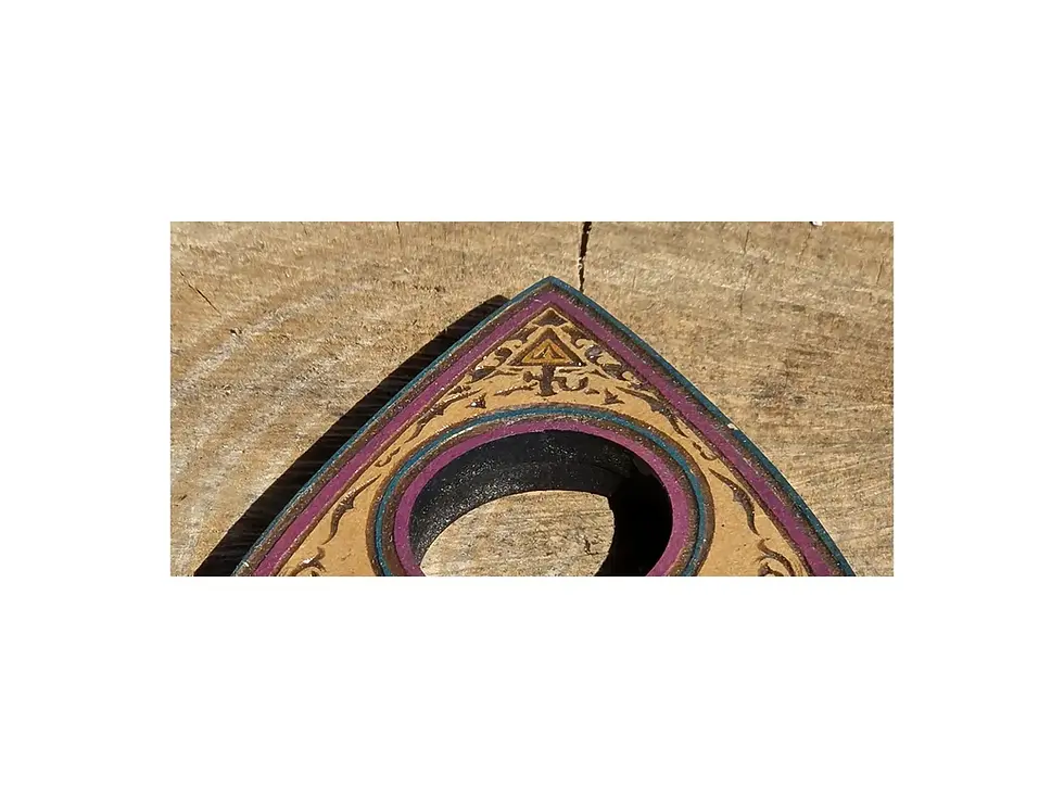 Thumbnail: Detail of the viewing aperture and painted symbolic artwork on the Mystic Blue Eye planchette