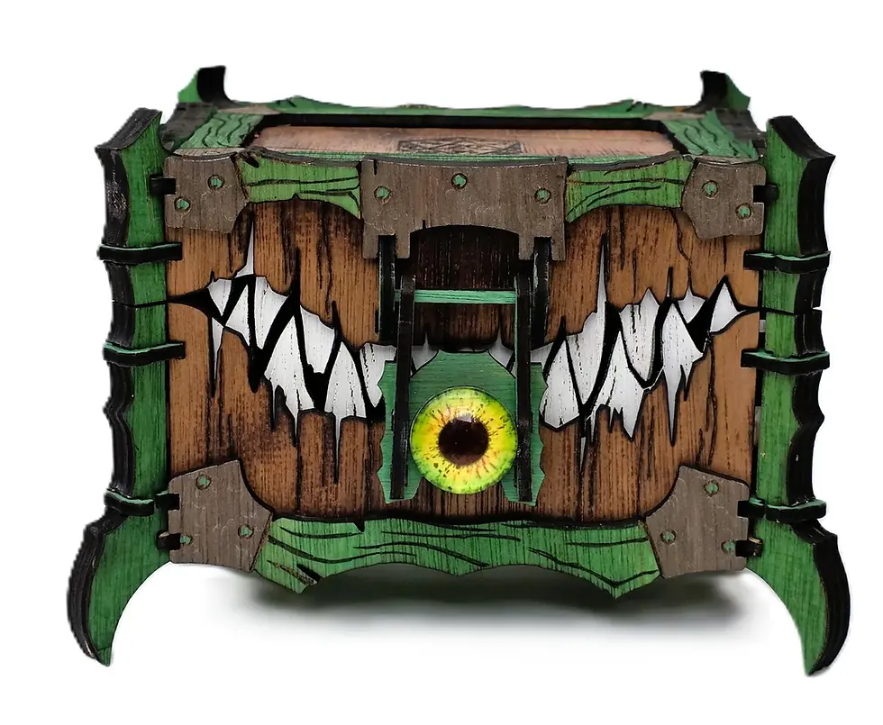 Front of the green large cyclops chest showing its eye detail, painted panels and jagged teeth.