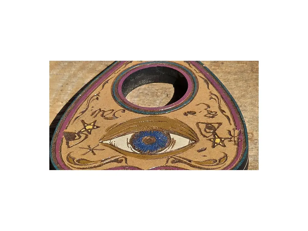 Thumbnail: Detailed view of the blue eye and lower engraved symbols on the Mystic planchette