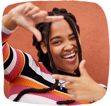 Black woman smiling in a striped sweater