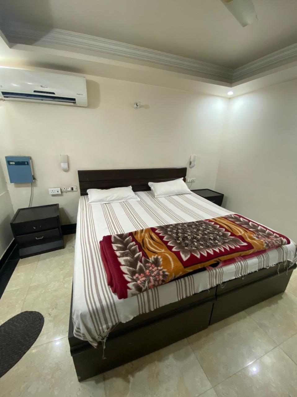 Cozy bedroom with a comfortable king size bed, adorned with elegant striped linens and a decorative throw. The room features 