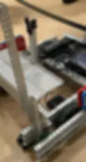 A close up picture of a VEX robot with a lever like mechanism.