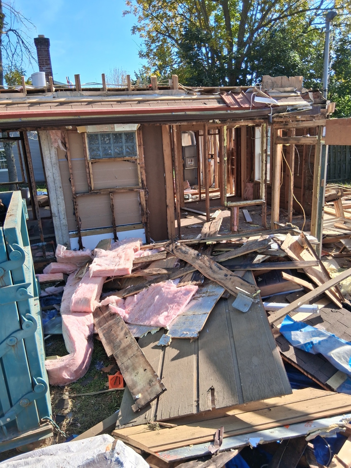 Demolition phase with existing wall framing exposed — Maverick Exteriors project