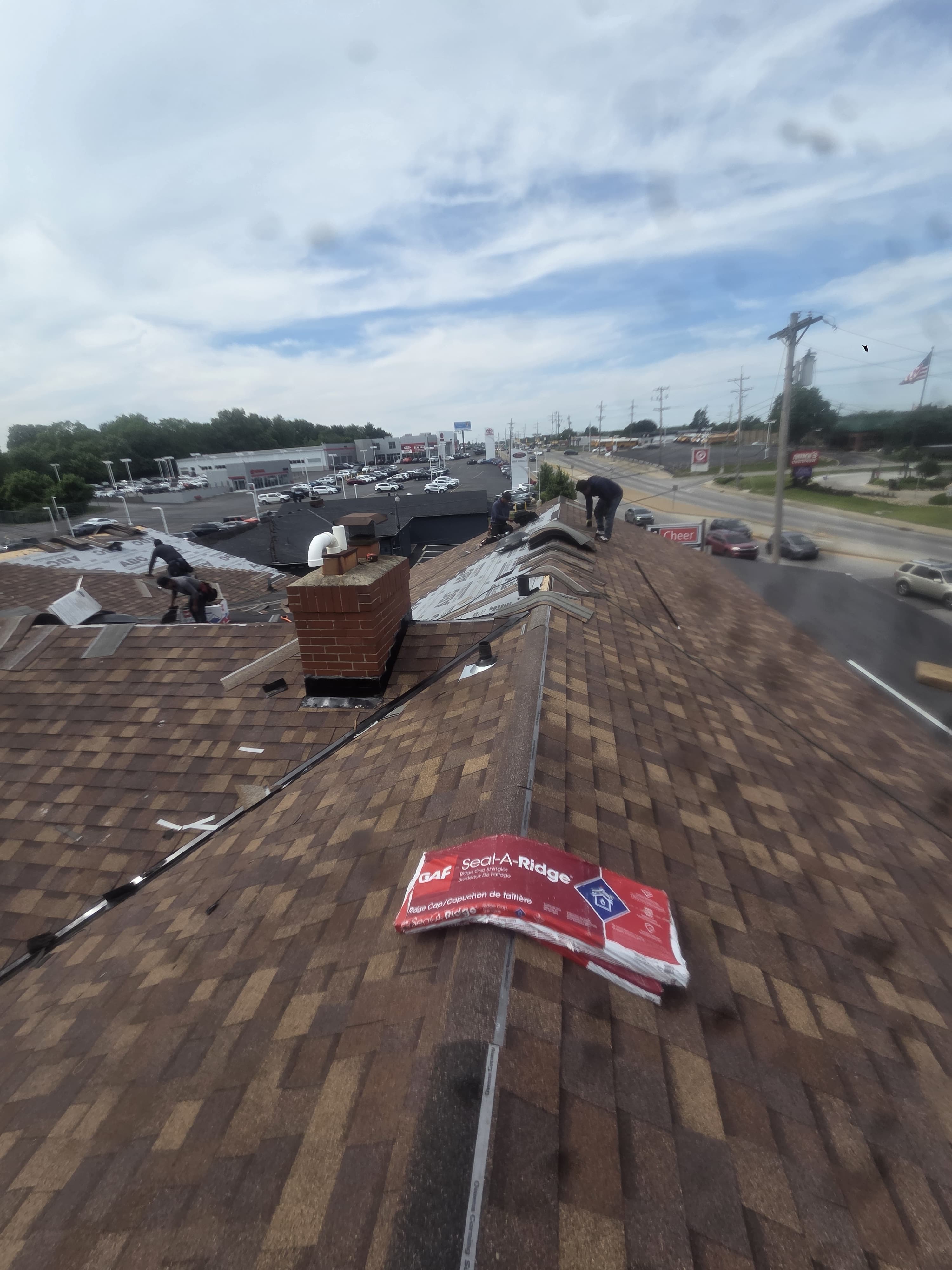 Shingle installation and roof material staging — Maverick Exteriors