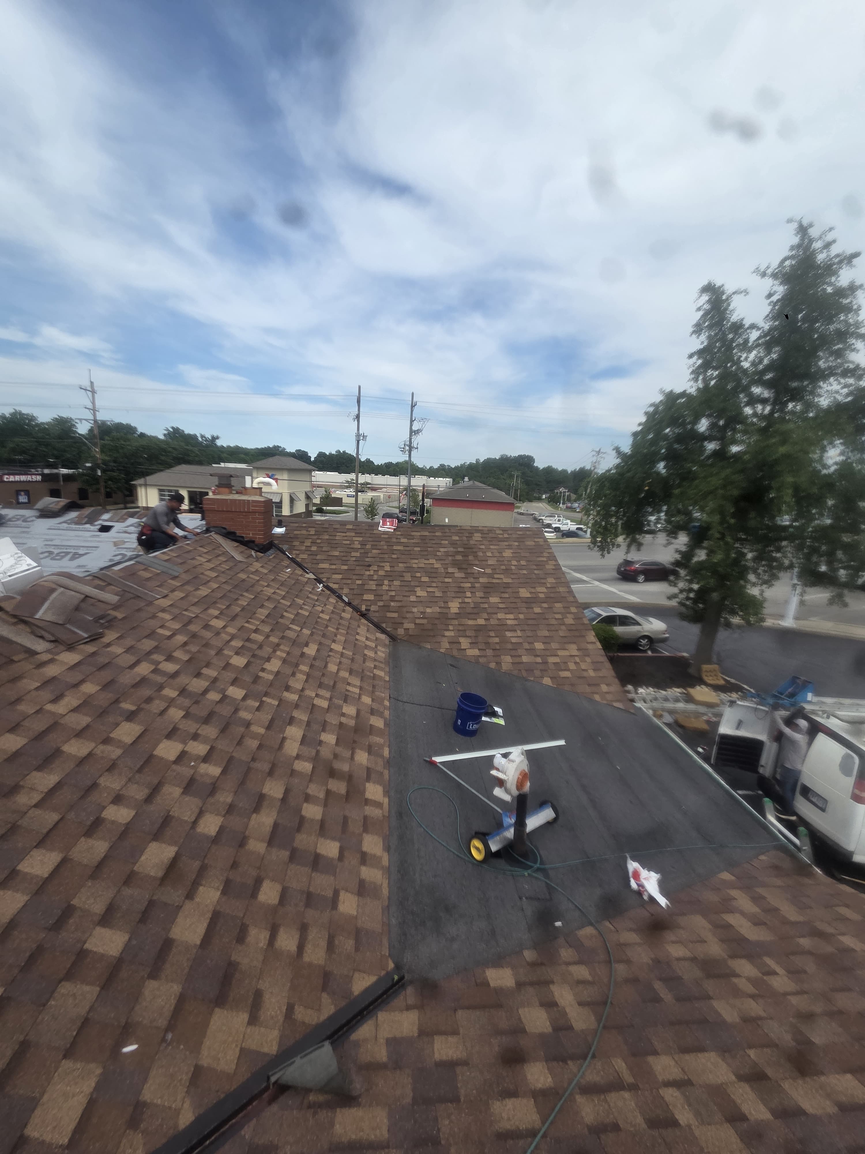 Roofing work around the chimney and low-slope section — Maverick Exteriors