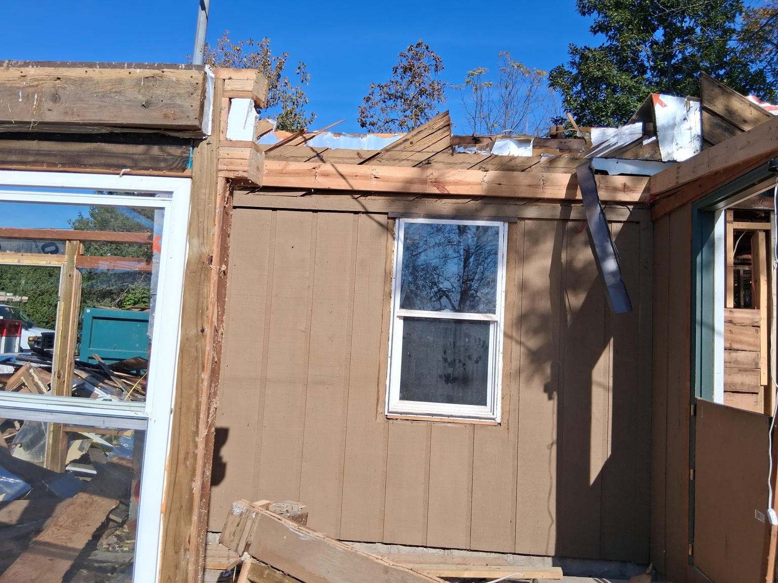 Exterior walls and window openings during demolition — Maverick Exteriors project