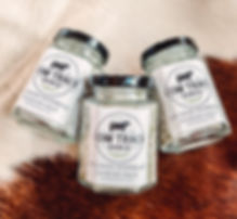 image of three jars of rosemary sea salt on cow hide background