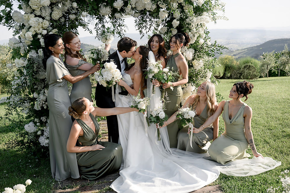 Bride and groom celebrating after the ceremony surrounded by guests during a destination wedding in Italy with floral aisle and joyful atmosphere