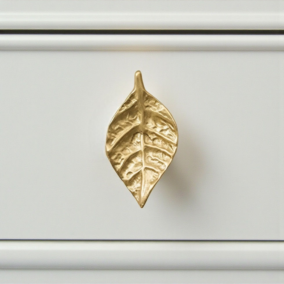 Thumbnail: Solid brass leaf cabinet and drawer knob with detailed veining and warm gold finish, mounted on a white drawer