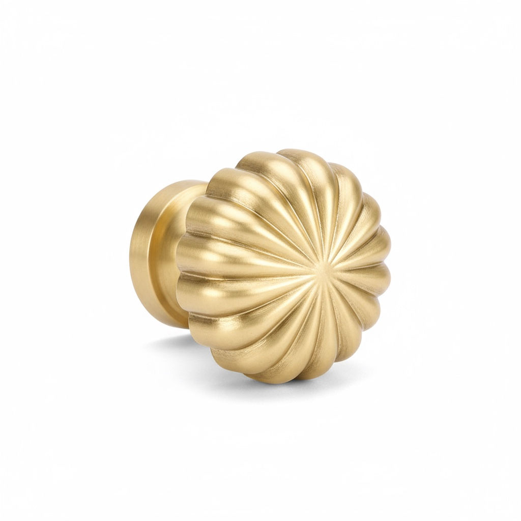 Solid brass starburst cabinet knob with sculpted radial design, brushed gold finish, suitable for cupboards and drawers