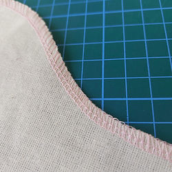 A neat overlock stitch will have balanced tensions, correct cutting width and the right differential