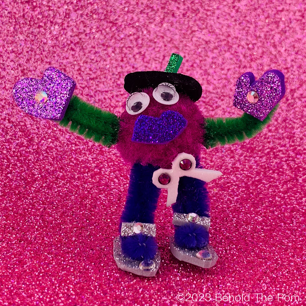 Purple cotton pom pom character with googly eyes and a beret poses in front of a pink glitter background