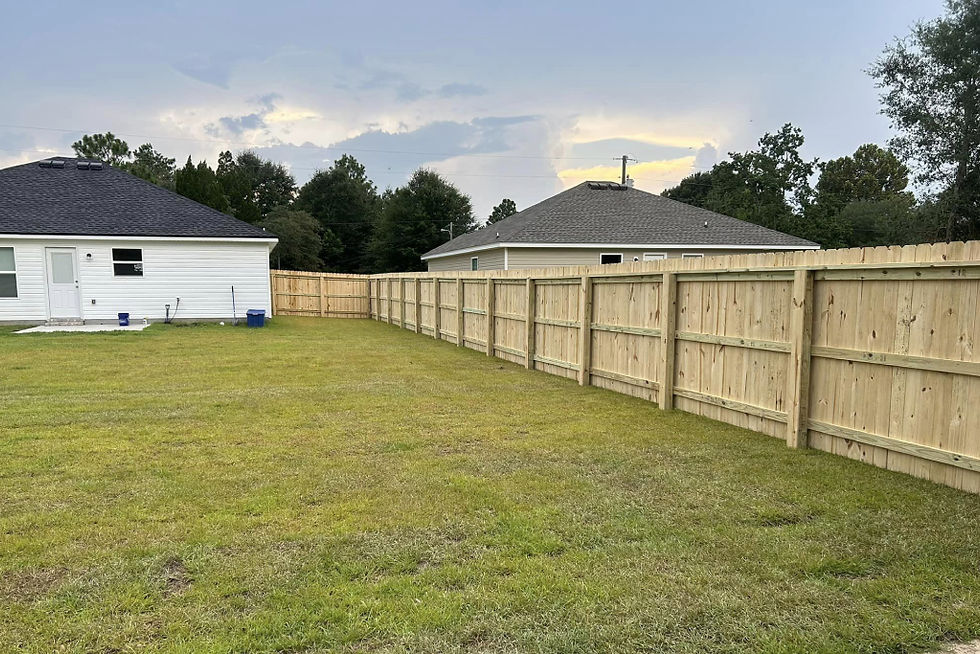 Tall privacy fence with solid panels enclosing a yard