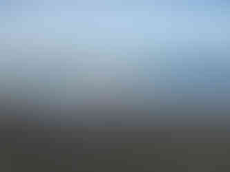 Girl running from the waves on the beach in California