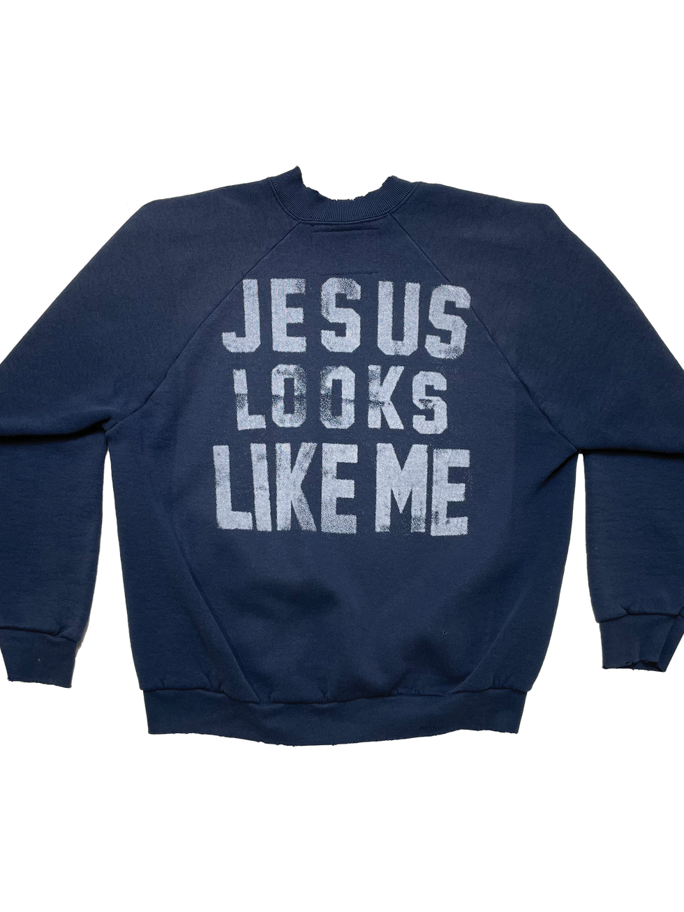 Back of crewneck with large white block text that says “Jesus Looks Like Me.”