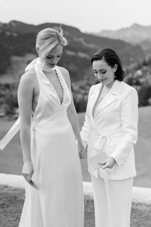 Romantic portrait of two brides with mountain backdrop — LGBTQ+ destination wedding in Gstaad, Switzerland.