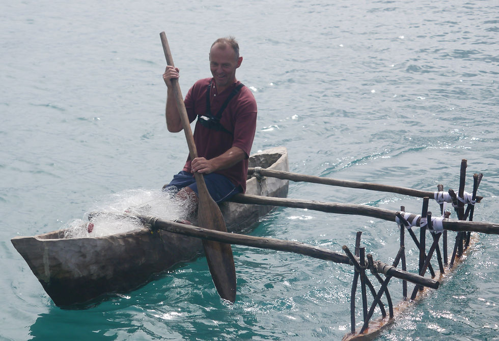 Skipper trying out a dugout canoe with outrigger