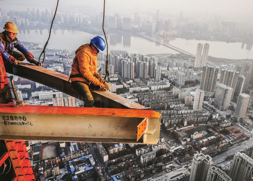 Photo from Hubei Art Museum depicting two workers on a skyscraper