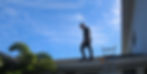 Inspector completing an inspection from on top of property roof.