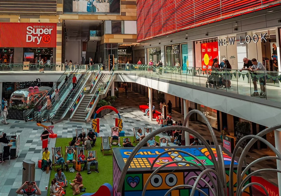 Bustling modern shopping mall interior with Super Dry and New Look stores.